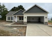 Charming, single-story home with a two-car garage, stone accents, and covered front porch at 47 Royal Ave, Selma, NC 27576