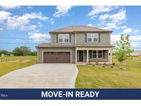 Inviting two-story home featuring a spacious driveway and attached two car garage at 48 Silver Ct, Smithfield, NC 27577