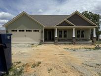 Charming single-story home featuring a two-car garage and covered front porch at 56 Bailey-Boykin Rd, Selma, NC 27576