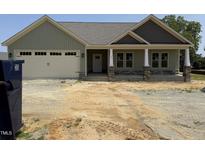 New construction home featuring a front porch with craftsman style pillars and attached two-car garage at 56 Bailey-Boykin Rd, Selma, NC 27576