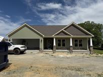 New construction shows a charming one-story home with stone accents and a two-car garage at 56 Bailey-Boykin Rd, Selma, NC 27576