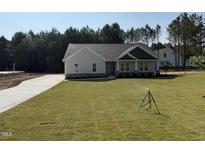 Charming single-story home with a well-manicured lawn and a long driveway at 612 Tuscany Cir, Princeton, NC 27569