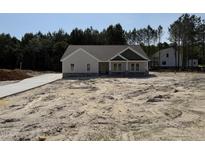 Charming single-story home with a combination of siding and stone accents, plus a new driveway at 612 Tuscany Cir, Princeton, NC 27569