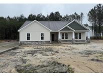 Charming new construction home with stone accents, covered entry, and professionally landscaped yard at 612 Tuscany Cir, Princeton, NC 27569