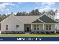 Charming single-story home with stone accents, neutral siding, covered porch, and manicured lawn at 612 Tuscany Cir, Princeton, NC 27569