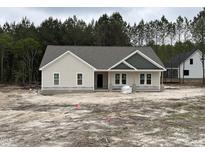 Charming single-story home featuring a mix of board and batten and shingle siding, creating an inviting curb appeal at 612 Tuscany Cir, Princeton, NC 27569
