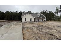 New construction exterior showcases a charming facade and well-manicured lawn at 612 Tuscany Cir, Princeton, NC 27569