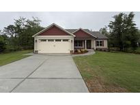 Charming single-story home featuring a spacious driveway, attached garage, and well-maintained lawn at 702 Tuscany Cir, Princeton, NC 27569