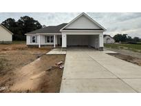 New construction with large driveway, partial stone, and ample room for parking and outdoor activities at 71 Royal Ave, Selma, NC 27576