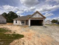 New construction home with an open garage and covered front porch in a serene, undeveloped neighborhood at 71 Royal Ave, Selma, NC 27576