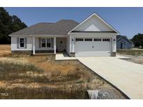 New construction boasts a two-car garage, stone accents and a covered porch, inviting you to call it home at 71 Royal Ave, Selma, NC 27576