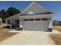 Charming home with a large two-car garage and bright white trim at 71 Royal Ave, Selma, NC 27576