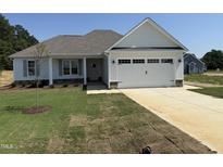 Charming single-story home featuring a spacious two-car garage and freshly sodded front yard at 71 Royal Ave, Selma, NC 27576