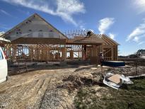 New home under construction with wood framing and sheathing against a blue sky at 76 Royal Ave, Selma, NC 27576