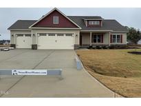 Charming single Gathering home featuring a three car garage and craftsman-style detailing at 76 Royal Ave, Selma, NC 27576
