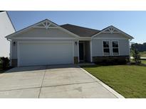 Charming single-story home featuring a two-car garage, stone accents, and a well-maintained front lawn at 8 W Emily Gardens Dr, Selma, NC 27576