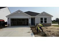 Charming single-Gathering home featuring stone accents, a two-car garage and landscaping in progress at 8 W Emily Gardens Dr, Selma, NC 27577