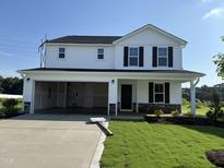 Charming two-story home with a spacious two car garage and well-maintained lawn at 82 W Emily Gardens Dr, Selma, NC 27576