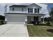 Charming two-story home with a two-car garage, beautiful landscaping, and a welcoming front porch at 82 W Emily Gardens Dr, Selma, NC 27576