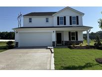 Charming two-story home with a two-car garage, manicured lawn, and stone accents at 82 W Emily Gardens Dr, Selma, NC 27576