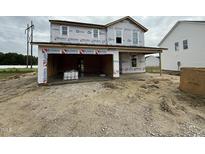 New two-story construction home featuring an attached two car garage at 82 W Emily Gardens Dr, Selma, NC 27577
