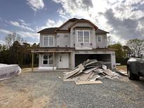 Two-story home under construction with visible framework, windows, and siding materials at 83 W Emily Gardens Dr, Selma, NC 27576