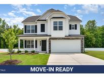 Charming two-story home with white siding, black shutters, and a well-manicured front lawn at 83 W Emily Gardens Dr, Selma, NC 27576
