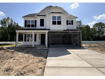 New two-story home with a spacious two-car garage and concrete driveway at 83 W Emily Gardens Dr, Selma, NC 27576