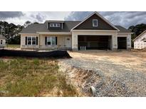 New construction home featuring a two-car garage and charming exterior details at 87 Tee Dr, Selma, NC 27576