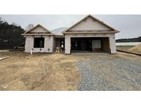 Exterior view of new construction featuring an attached two-car garage at 89 W Emily Gardens Dr, Selma, NC 27576