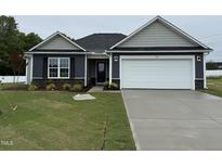 Charming single-story home featuring a two-car garage, well-manicured lawn, and appealing curb appeal at 89 W Emily Gardens Dr, Selma, NC 27576