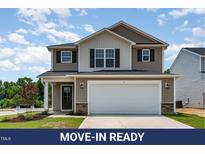 Charming two-story home showcasing a two-car garage, neutral siding, and a well-manicured front lawn at 9 W Emily Gardens Dr, Selma, NC 27576