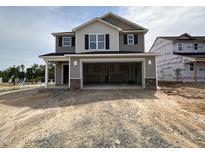 New construction two-story home featuring a large two-car garage and neutral toned exterior at 9 W Emily Gardens Dr, Selma, NC 27576