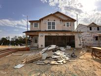 New construction home featuring an attached two-car garage and partially completed exterior at 9 W Emily Gardens Dr, Selma, NC 27576
