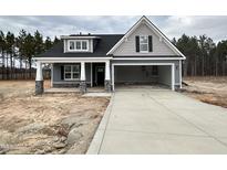 Charming single Gathering home with a wide driveway and inviting covered front porch at 98 Laramie Ln, Selma, NC 27576
