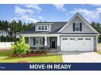 Charming one-story home featuring a two-car garage and landscaped front yard at 98 Laramie Ln, Selma, NC 27576