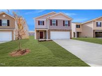 Charming two-story home with a spacious two-car garage and well-maintained lawn at 2149 Monk Dr, Haw River, NC 27258