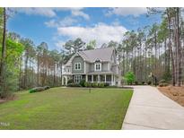 Charming two-story home with a long driveway and landscaped front yard at 2408 Merion Creek Dr, Apex, NC 27539