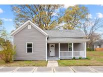 Charming single-story home with gray siding, covered porch, and well-maintained front yard at 312 E Highland Ave, Rocky Mount, NC 27801