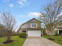 Charming two-story home featuring a two-car garage, manicured lawn, and inviting curb appeal at 400 Collington Dr, Mebane, NC 27302