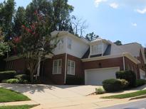 Charming two-story brick home with well-manicured landscaping and a spacious driveway, under a clear blue sky at 4203 Norman Ridge Ln, Raleigh, NC 27613