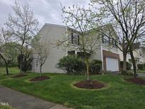Charming two-story home featuring a well-manicured front yard with lush greenery and fresh mulch at 4610 Miller Dr, Durham, NC 27704