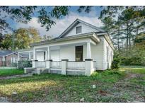 Charming home with inviting front porch and classic architectural details in a suburban landscape at 703 Cokey Rd, Rocky Mount, NC 27801