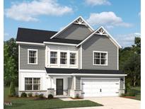 Charming two-story home featuring gray siding, a two-car garage, and a well-manicured lawn in a suburban setting at 709 Compeer Way # 32, Rolesville, NC 27571