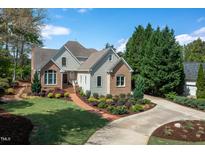 Beautiful two-story home with brick and siding exterior and a lovely, landscaped front yard at 8713 Gleneagles Dr, Raleigh, NC 27613