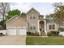 Charming two-story home featuring a two-car garage and well-manicured lawn at 1008 Double Spring Ct, Apex, NC 27502