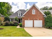 Charming brick home with a well-manicured lawn and a two-car garage at 109 Yorkchester Way, Raleigh, NC 27615