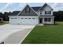 Charming two-story home with a three car garage, manicured lawn and inviting curb appeal at 112 Surles Landing Way, Benson, NC 27504