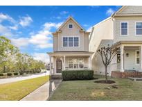 Charming two-story home with a cozy front porch and manicured lawn at 115 Windy Creek Ln, Apex, NC 27502