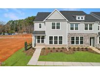 New two-story townhome with gray siding, brick accents, manicured lawn and front walkway at 1427 Goldsboro Ave, Sanford, NC 27330